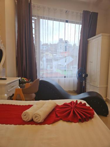 a bedroom with a bed with a red bow on it at Love Hotel - Khách Sạn Theo Giờ in Da Lat