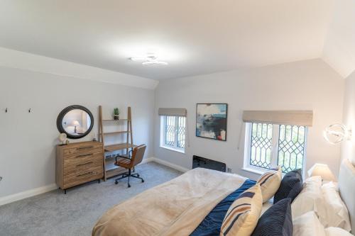 a person laying on a bed in a bedroom at The Enchanting Silver Birch Retreat, New Forest in Ower
