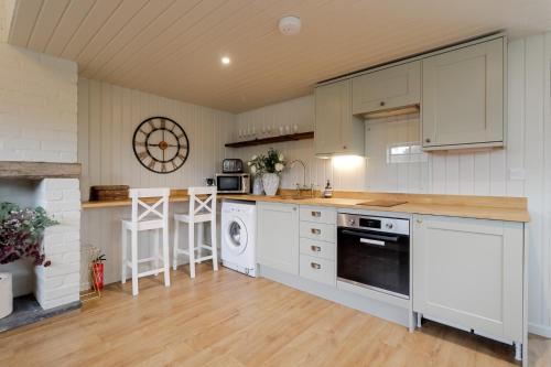 a kitchen with white cabinets and a stove top oven at 1 bed home in Eckington in Eckington
