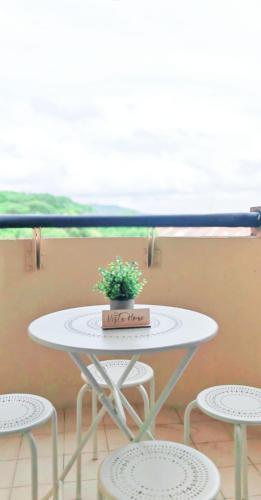 a white table with a potted plant on top of it at Vista Home in Kajang