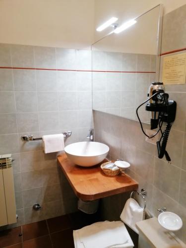 a bathroom with a white sink and a mirror at Albergo Sella - Monte Amiata in Abbadia San Salvatore