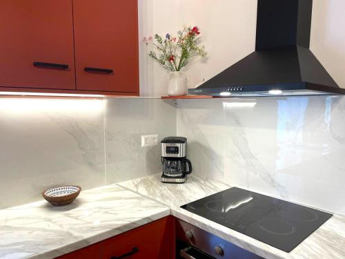 a kitchen with a stove and a counter top at March in Kontokali