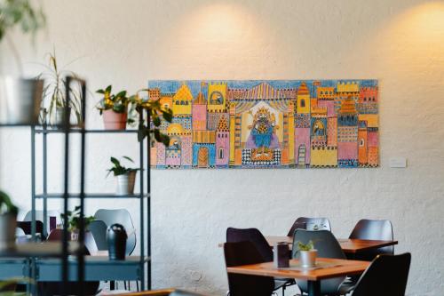 a painting hanging on a wall in a restaurant at Hotel Sverre in Sandnes