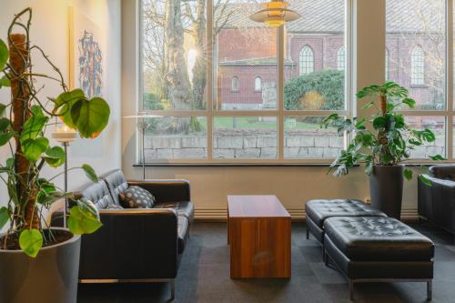a living room with a couch and a table at Hotel Sverre in Sandnes