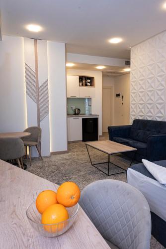 a living room with oranges in bowls on a table at Rooftop Apart-Hotel in Yerevan