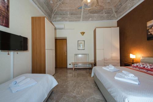 House Montebello في روما: غرفة فندقية بسريرين وتلفزيون بشاشة مسطحة