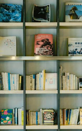 a book shelf filled with lots of books at WeBase Hakata Hostel in Fukuoka
