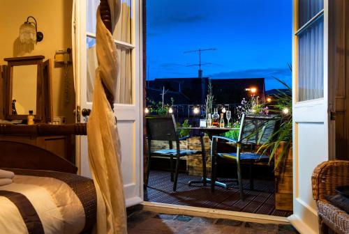a room with a door open to a balcony with a table at Baldwin House in Stourport