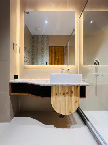 a bathroom with a sink and a mirror at Hotel Virasat-E-Bushahr in Rāmpur