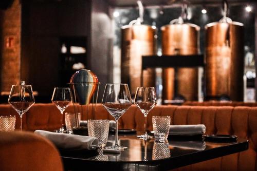 a table in a restaurant with wine glasses on it at HO Puerta de Purchena By Olivencia in Almería