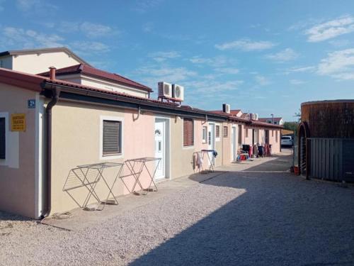 a row of buildings with chairs on a street at Apartmani Betina-Murter in Betina