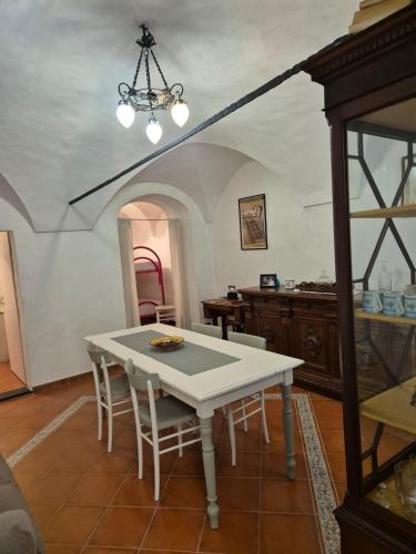a dining room with a white table and chairs at Ca du Bersagliè in centro di Badalucco in Badalucco