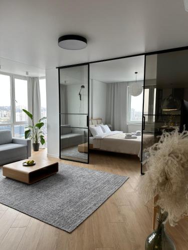a large white room with a bed and a couch at Апартаменти Мон Блан in Khmelʼnytsʼkyy
