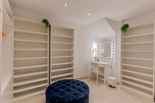 a dressing room with shelves and a blue stool at Charming semi- detached villa in Mirador del Duque in Adeje