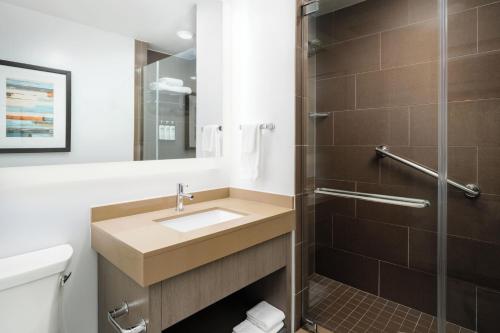 a bathroom with a sink and a shower at Hyatt House Naples 5th Avenue in Naples