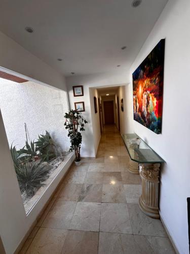 a hallway with a painting hanging on a wall at Casa Hendrika - La Nucia Hills in La Nucía