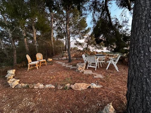 a patio with chairs and a table in the woods at Casa Hendrika - La Nucia Hills in La Nucía