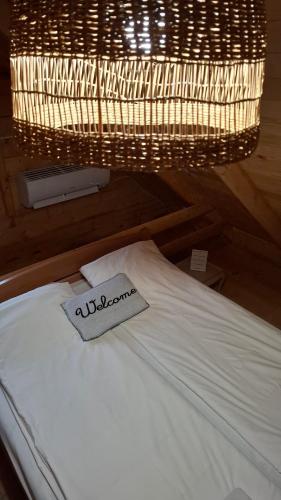 a bed with a napkin on it under a chandelier at Kuća za odmor Stara Jabuka in Ledinci
