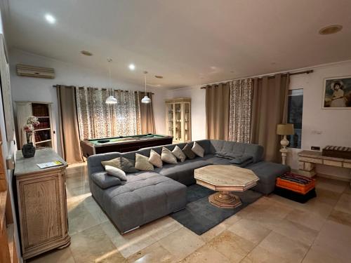 a living room with a couch and a pool table at Casa Hendrika - La Nucia Hills in La Nucía