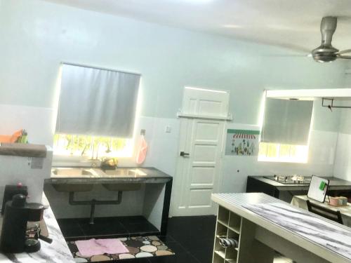 a kitchen with a sink and a counter top at Ang Rest House in Kuala Rompin