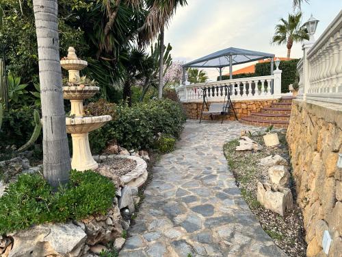 a stone walkway with a fountain in a yard at Casa Hendrika - La Nucia Hills in La Nucía