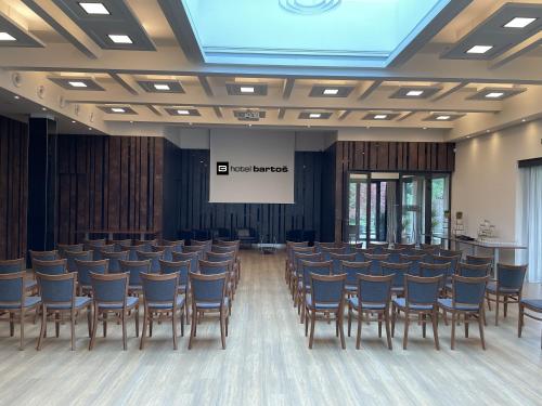 a conference room with chairs and a screen at Hotel Bartoš in Frenštát pod Radhoštěm