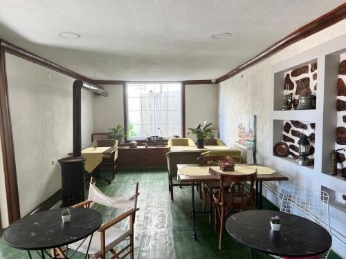 a room with tables and chairs and a fireplace at İnebolu Eskonak Otel in Inebolu