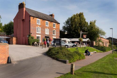 a group of people sitting outside of a building at Baldwin House in Stourport