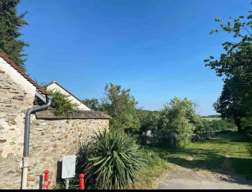 a stone house with a garden and a driveway at Quiet house near Disneyland in Quincy-Voisins