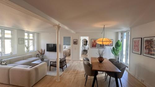 a living room with a couch and a table at Løvstræde apartments from 1 to 6 in Copenhagen