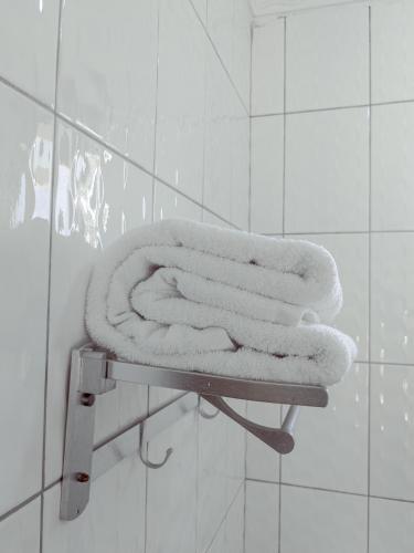a pile of towels on a shelf in a bathroom at Durban Hotel in Dar es Salaam