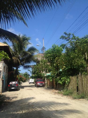 a street with cars parked on the side of a road at La Facha Hostal Restaurant Surf in Mompiche