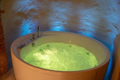 a bath tub filled with green slime in a bathroom at Lajatico Rentals -Grotticella House, SPA Apartment in Peccioli in Peccioli