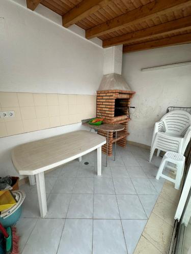 a kitchen with a table and a brick oven at Ericeira Dream Stay in Ericeira