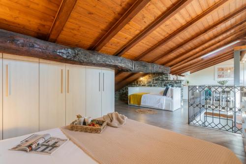 a bedroom with a bed and a wooden ceiling at Domus in Como by Rent All Como in Como
