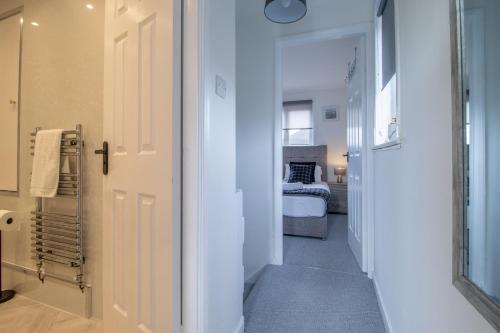 a hallway with a door leading to a bedroom at Spacious 2-Bed City Home Free Parking & Stadiums in Glasgow
