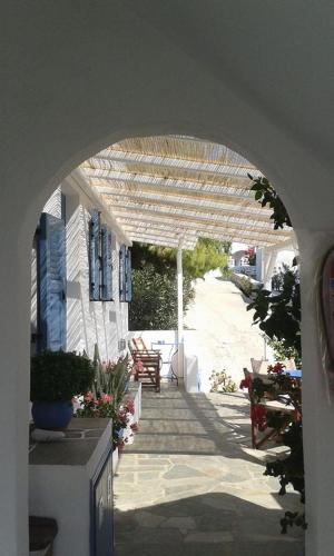 an archway leading to a house with a patio at Artemis Rooms in Chora Folegandros