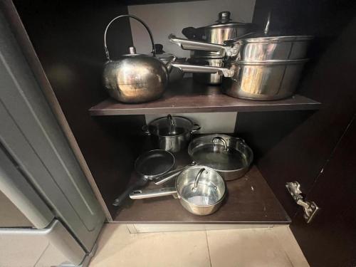 a group of pots and pans on a shelf in a kitchen at Blue Dream in San Francisco in Panama City