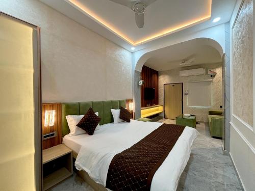 a bedroom with a large bed in a room at Hotel Ambassador Varanasi in Varanasi