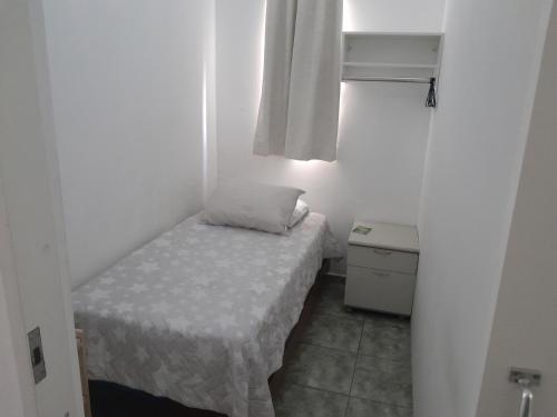 a small room with a small bed and a window at Pensionato Nosso lar in Jandira
