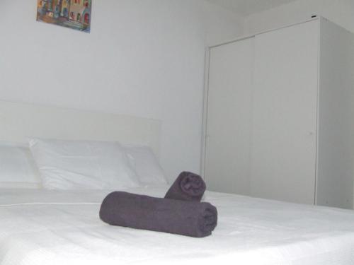 a towel on a bed in a bedroom at Sunny Penthouse Central in Mosta