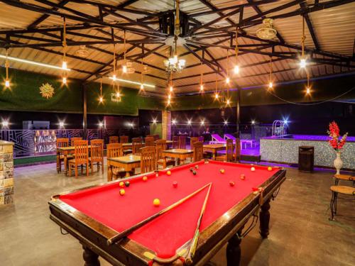 a pool table in a room with tables and chairs at LA Riqueza Pride Inn # Rootop Swimming Pool with Mountain View # Free Parking # Tapovan # Center of Rishikesh# in Rishīkesh