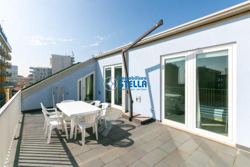 a balcony with a table and chairs on a building at Residence Adriatica in Lido di Jesolo
