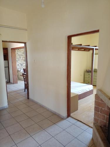 a bedroom with a bed and a mirror at Agrotourism Traditional Houses in Apóstoloi