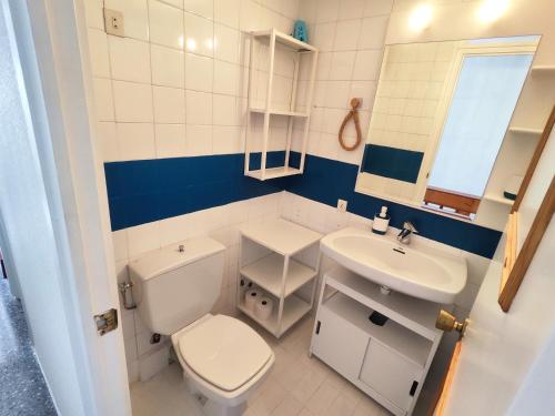 a small bathroom with a toilet and a sink at Apartamentos con vistas al mar in Platja  d'Aro