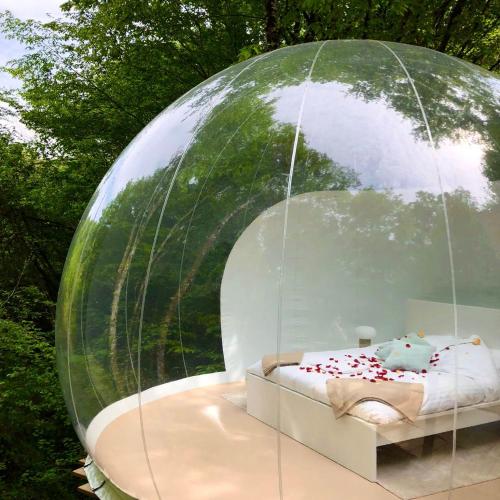 a bedroom in a dome with a bed inside at Cabanes de la Romaningue in Pompignac