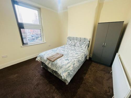 a bedroom with a bed and a window at Double Room Near Railway station & Football Ground 88 in Nottingham