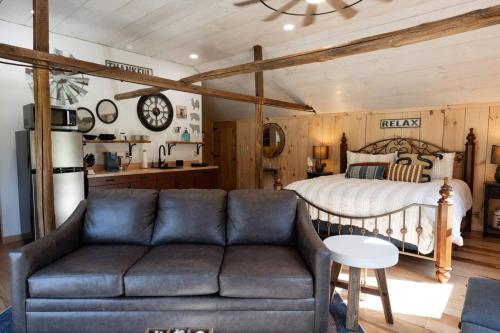 a living room with a couch and a bed at Couples Retreat - The HayLoft- Rustic Escape For 2 in Oakland