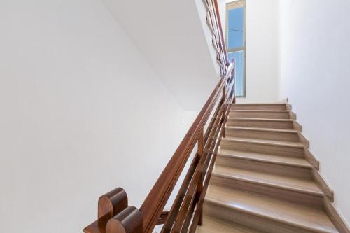 a staircase with wooden railings in a building at Appartamenti Fontana by BarbarHouse in San Pietro in Bevagna
