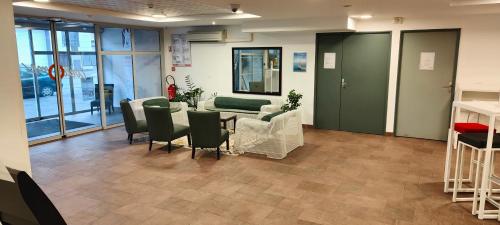 a meeting room with a table and chairs in a building at Aparthotel Adagio Access Poitiers in Poitiers